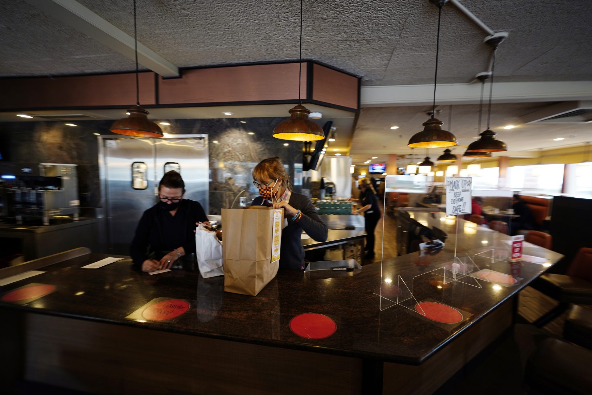 Managers Yllka Murati, left, and Cynthia Branche organize takeout orders at the Penrose Diner, Tuesday, Nov. 17, 2020, in south Philadelphia.