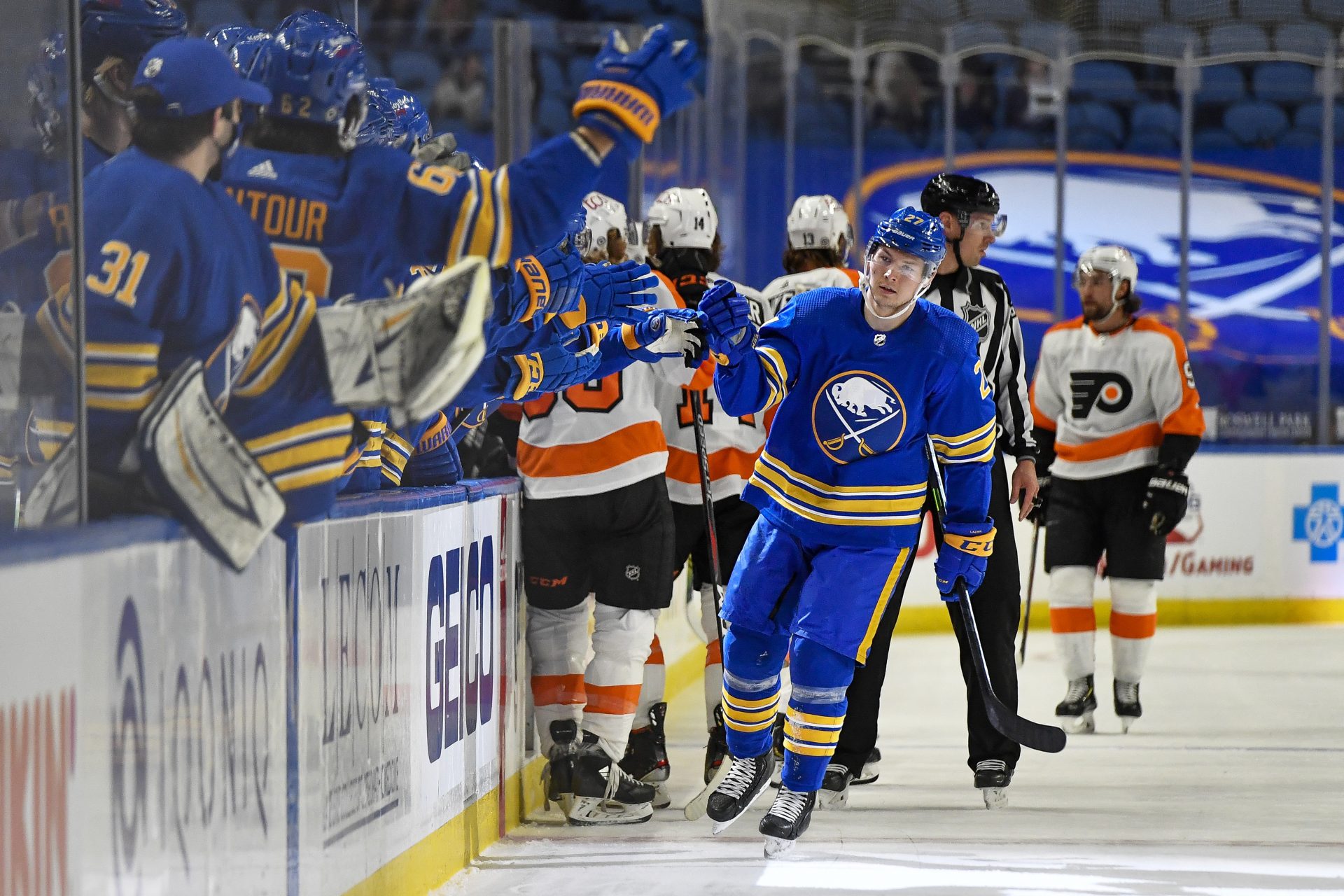 Buffalo Sabres center Curtis Lazar (27) is congratulated after scoring against the Philadelphia Flyers during the first period of an NHL hockey game in Buffalo, N.Y., Wednesday, March 31, 2021.