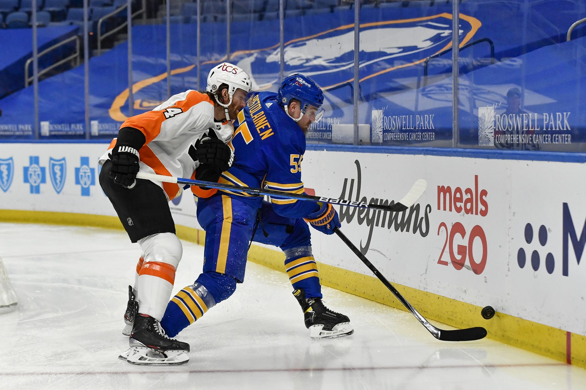 Buffalo Sabres defenseman Rasmus Ristolainen (55) clears the puck while pressured by Philadelphia Flyers center Sean Couturier (14) during the first period of an NHL hockey game in Buffalo, N.Y., Wednesday, March 31, 2021.