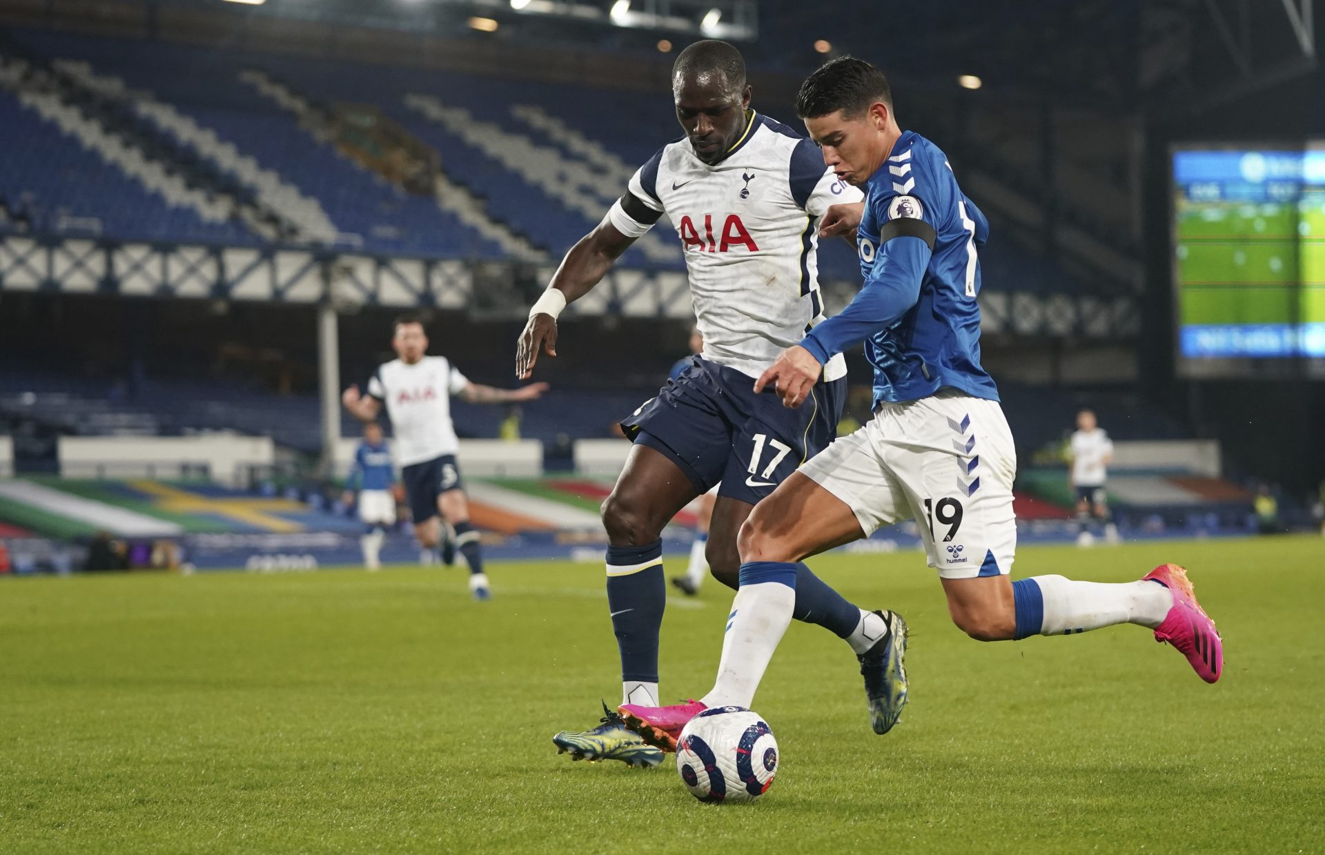 Everton's James Rodriguez, front, duels for the ball with Tottenham's Moussa Sissoko during the English Premier League soccer match between Everton and Tottenham Hotspur at Goodison Park in Liverpool, England, Friday, April 16, 2021.