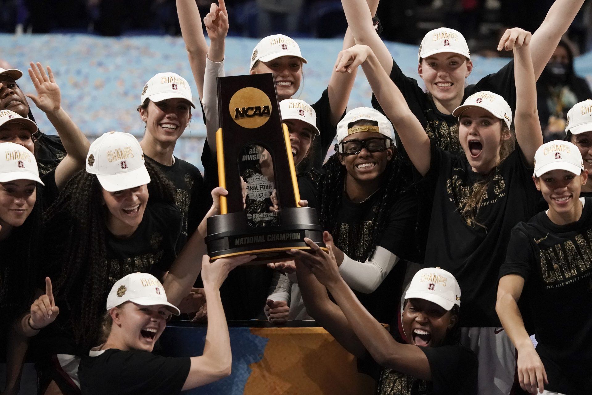 Stanford players celebrate with the trophy after the championship game against Arizona in the women's Final Four NCAA college basketball tournament, Sunday, April 4, 2021, at the Alamodome in San Antonio. Stanford won 54-53.