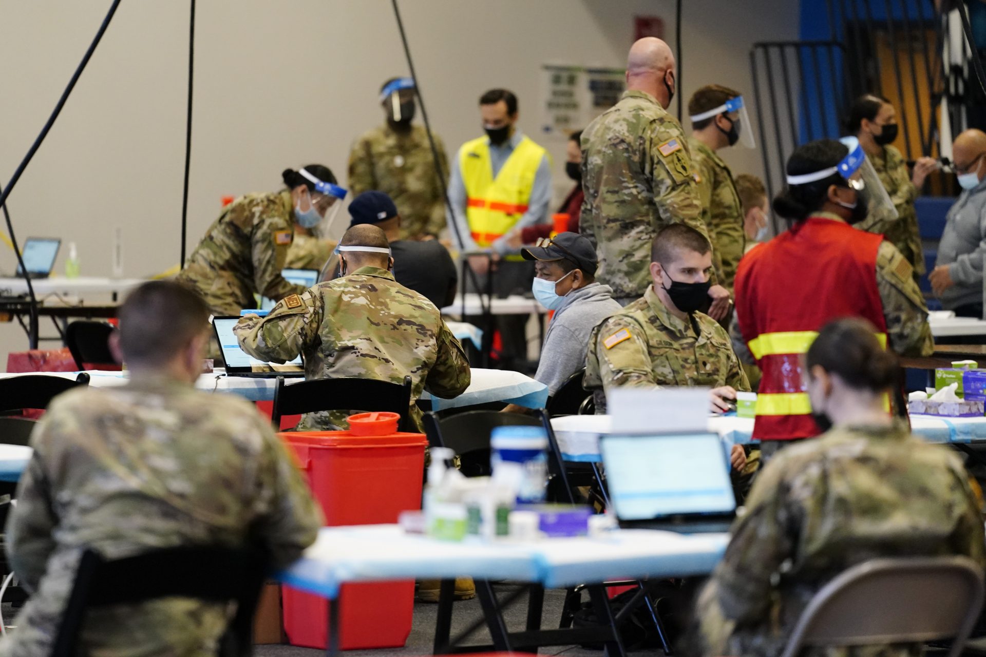 Members of the military inoculate people with the Johnson & Johnson COVID-19 vaccine at the Esperanza Community Vaccination Center in Philadelphia, Friday, April 9, 2021.