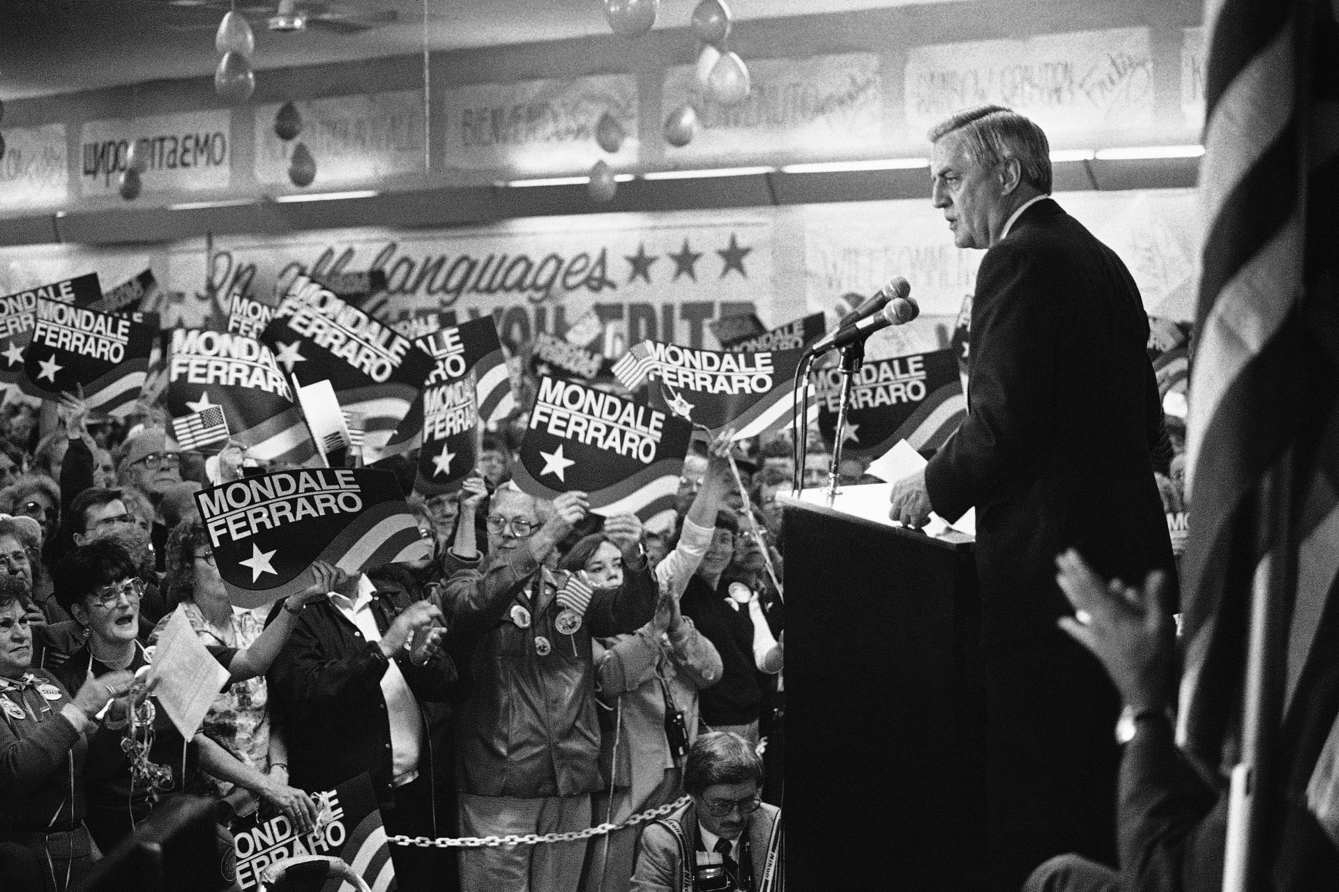 In this Wednesday, Oct. 14, 1984, file photo, a sign-waving crowd cheers Democratic presidential candidate Walter Mondale, right, as he delivers a campaign address at Victory Hall in the Milwaukee suburb of Cudahy, Wis.