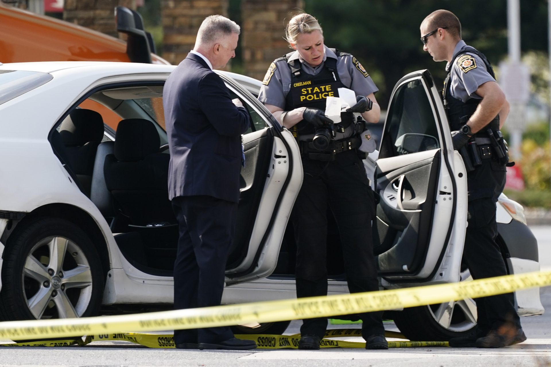 Crime investigators work the scene at a Wawa convenience store and gas station in Breinigsville, Pa., Wednesday, April 21, 2021.