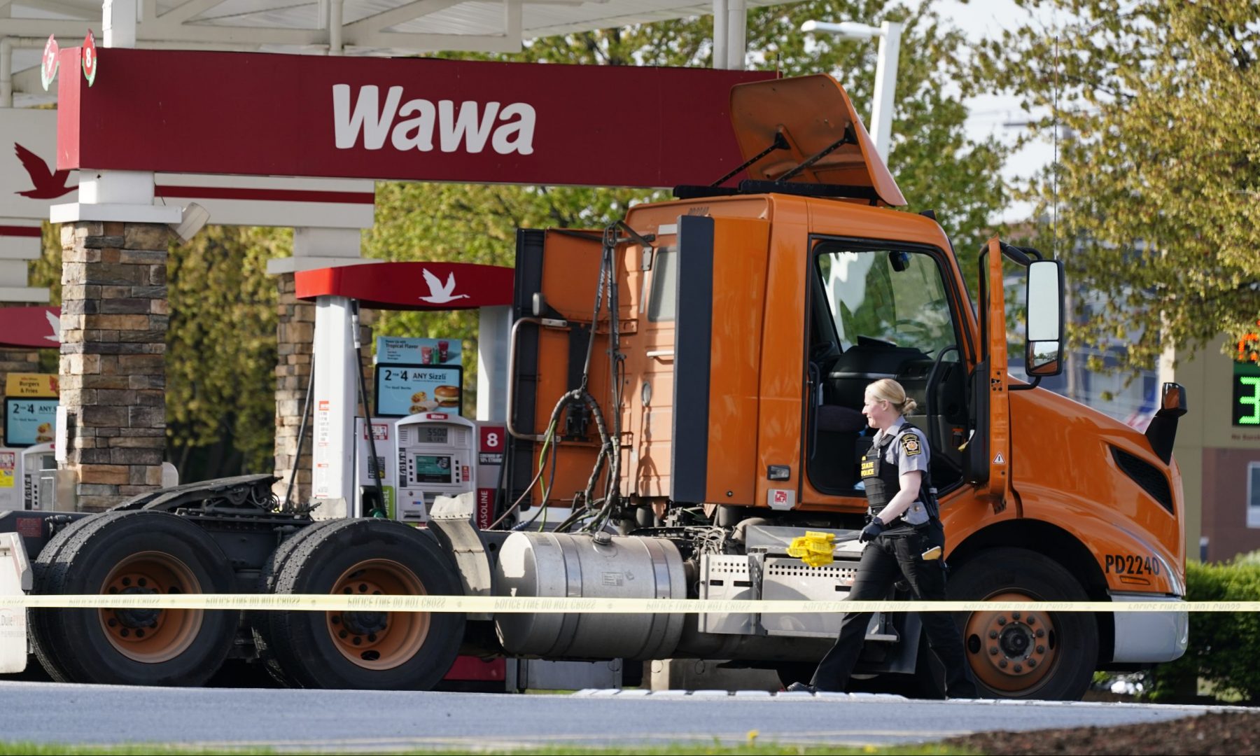 An investigator works the crime scene at a Wawa convenience store and gas station in Breinigsville, Pa., Wednesday, April 21, 2021. Police on Wednesday converged on a convenience store in eastern Pennsylvania following what state police called a 