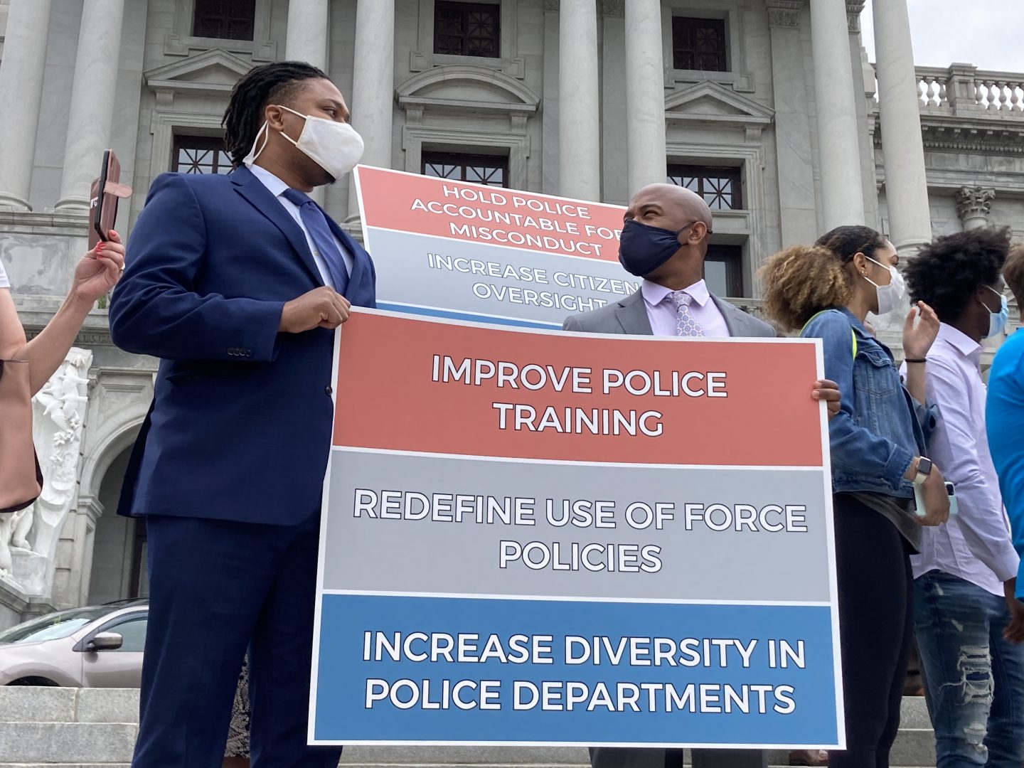 Rep. Malcolm Kenyatta (D-Philadelphia) and Rep. Napoleon Nelson (D-Montgomery) hold a sign during a May 25, 2021 rally remembering the one-year anniversary of George Floyd's murder. 