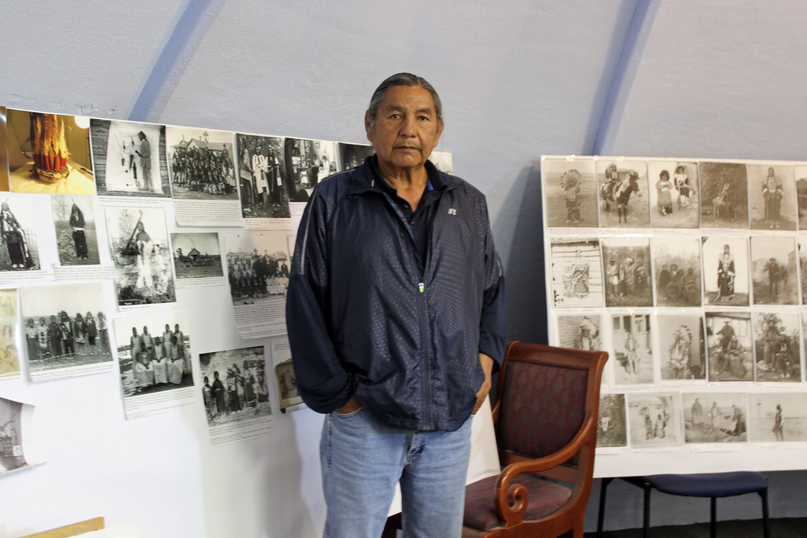 In this May 6, 2016, photo, Russell Eagle Bear, the historic preservation officer for the Rosebud Sioux Tribe, stands in his office in in Rosebud, S.D. Eagle Bear led a meeting between leaders of several tribes, including the Rosebud Sioux Tribe, and representatives from the U.S. Army to address the possibility of repatriating the remains of at least 10 Native American children who died away from their homes while being forced to attend the government-run Carlisle Indian Industrial School in Pennsylvania more than a century ago. 