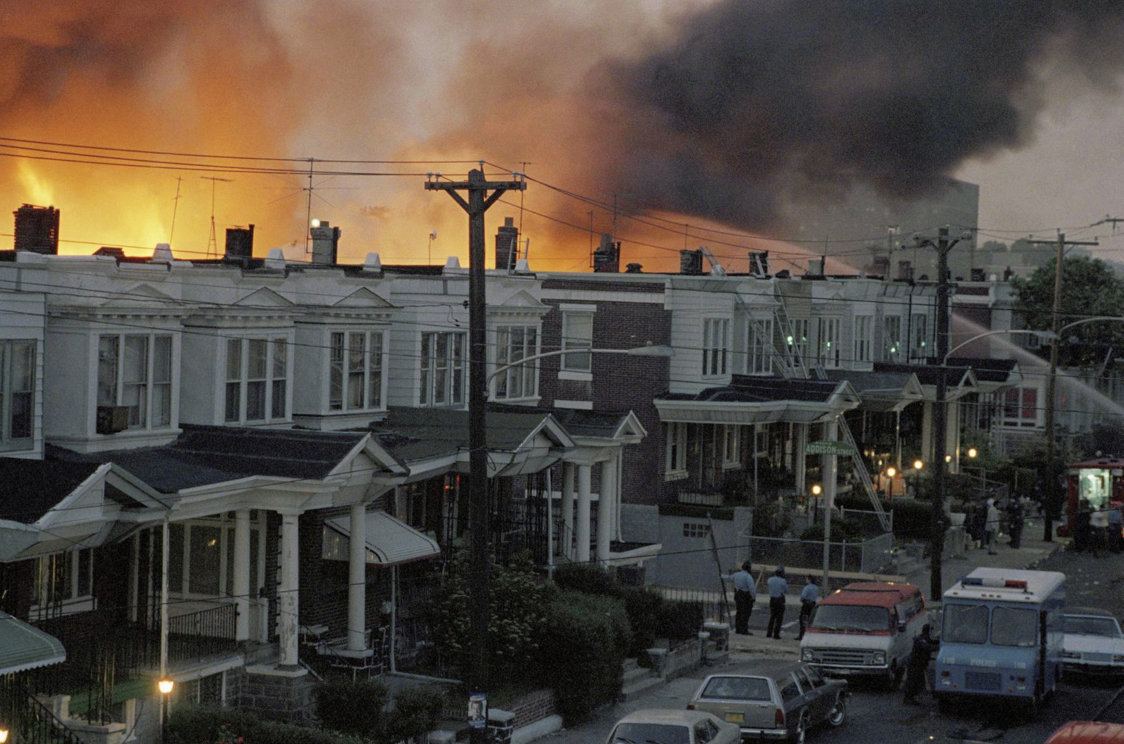 FILE - In this May, 1985 file photo, scores of row houses burn in a fire in the west Philadelphia neighborhood. Police dropped a bomb on the militant group MOVE's home on May 13, 1985 in an attempt to arrest members, leading to the burning of scores of homes in the neighborhood. A day after Philadelphia's health commissioner was forced to resign over the cremation of partial remains thought to belong to victims of a 1985 bombing of the headquarters of a Black organization, the city now says those victims' remains were never destroyed. City officials told the victims' family Friday, May 14, 2021 that a subordinate had disobeyed Health Commissioner Thomas Farley’s 2017 order to dispose of the remains. (AP Photo/File)