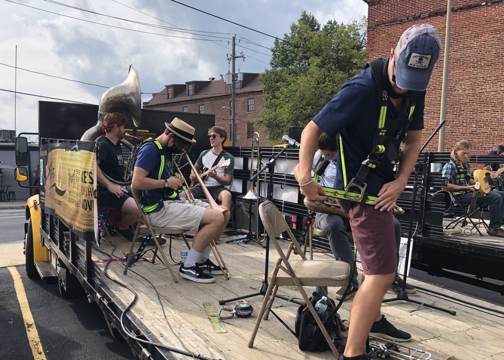 The Big Boy Brass band strapping themselves onto the back of a flatbed truck.