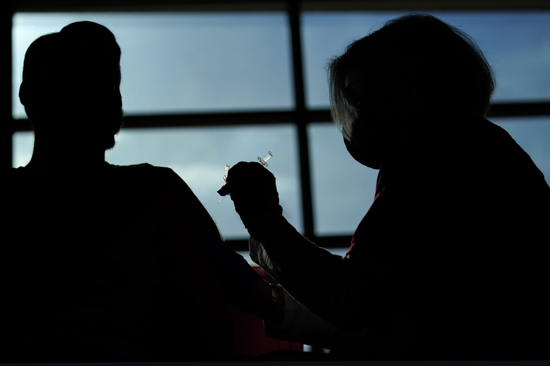 Philadelphia Flyers ice crew member Ryan DiFilipo, left, receives a Johnson & Johnson COVID-19 vaccination from nurse practitioner Erin McMenamin at the Wells Fargo Center before an NHL hockey game against the New Jersey Devils, Monday, May 10, 2021, in Philadelphia.