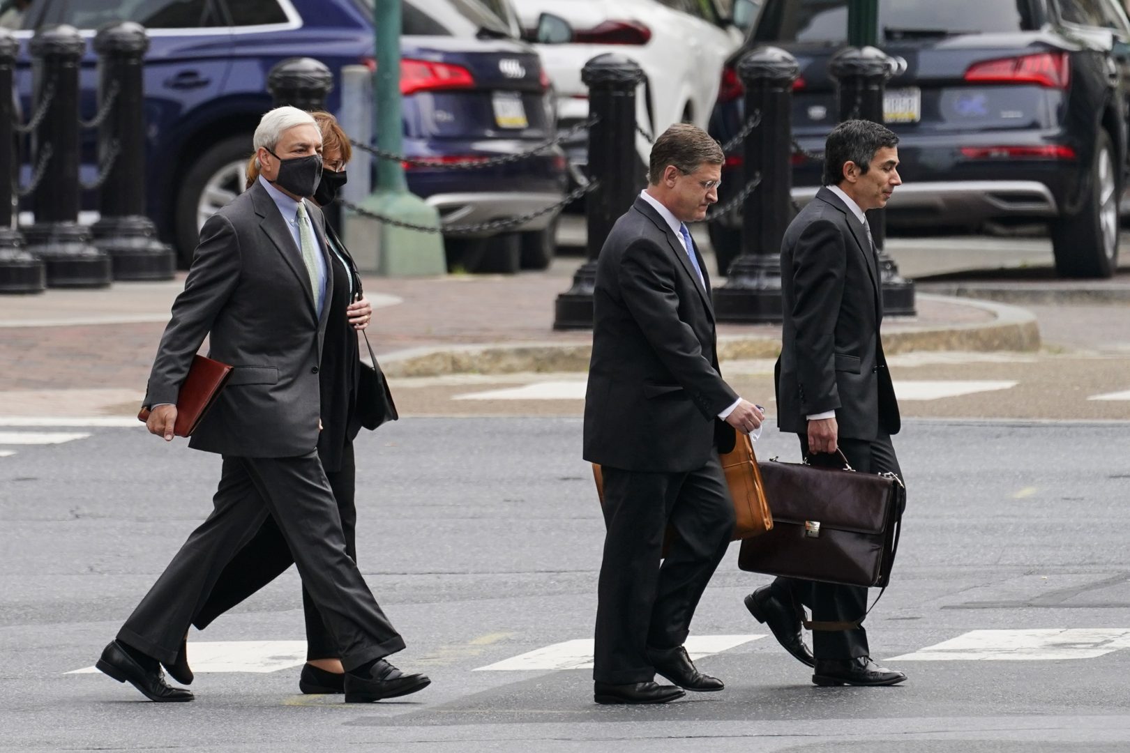 Former Penn State President Graham Spanier, left, walks to his hearing at the Dauphin County Courthouse in Harrisburg, Pa., Wednesday, May 26, 2021.   A judge will determine if and when Spanier must report to jail to begin serving time for a single misdemeanor conviction of endangering the welfare of children.