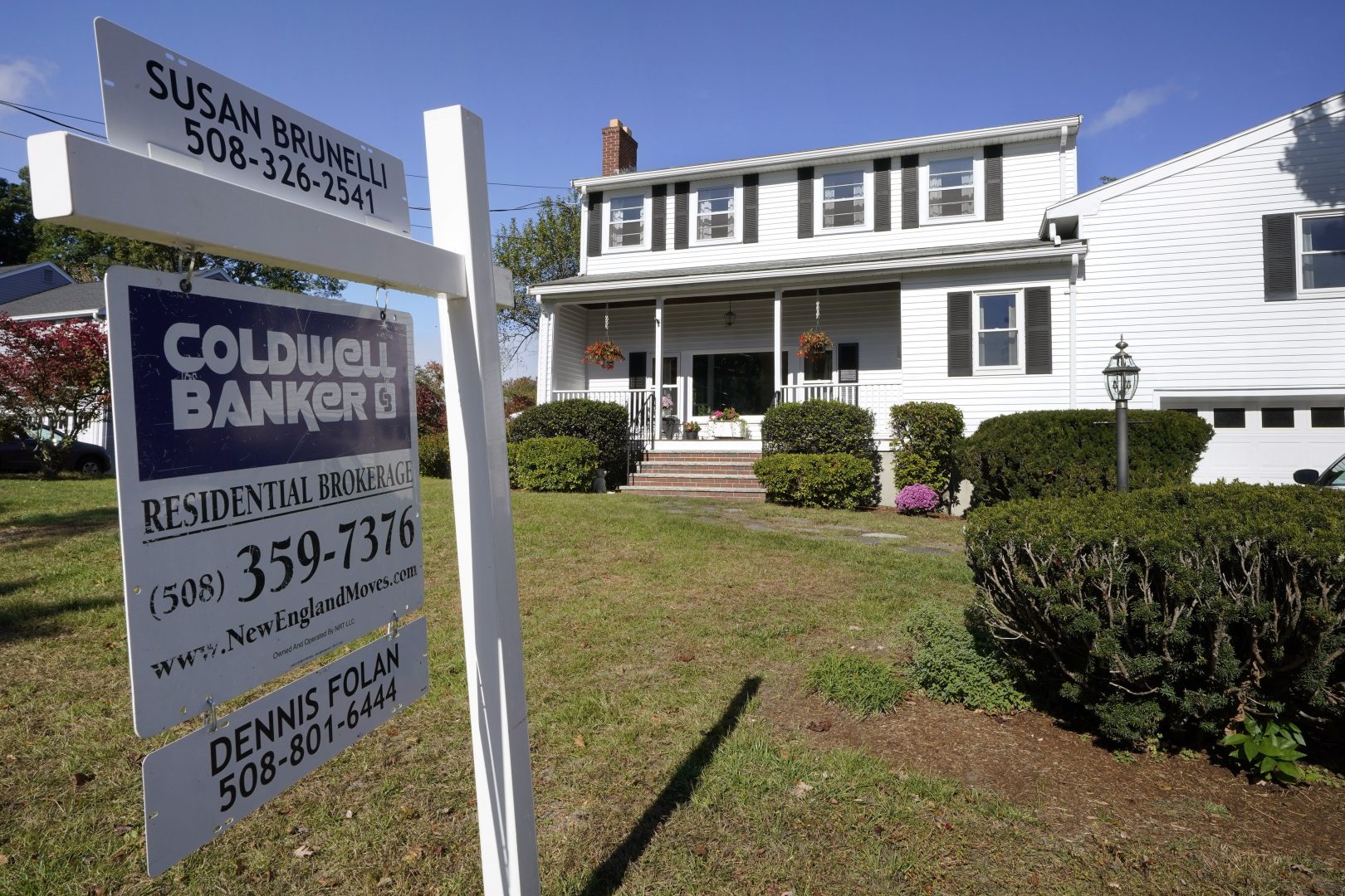 In this 2020 file photo, a real estate brokerage sign stands in front of a house in Norwood, Mass.