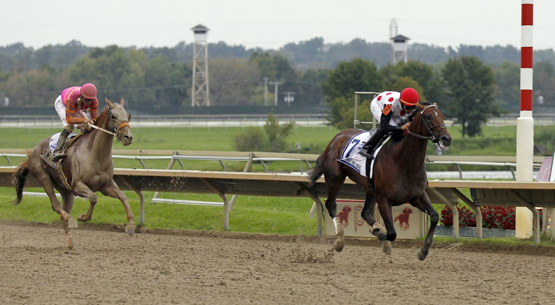 To Honor and Serve, right, with jockey Jose Lezcano, crosses the finish line in front of Ruler on Ice, with jockey Garrett Gomez, to win during the Pennsylvania Derby horse race at Parx Racing on Saturday, Sept. 24, 2011, in Bensalem, Pa.