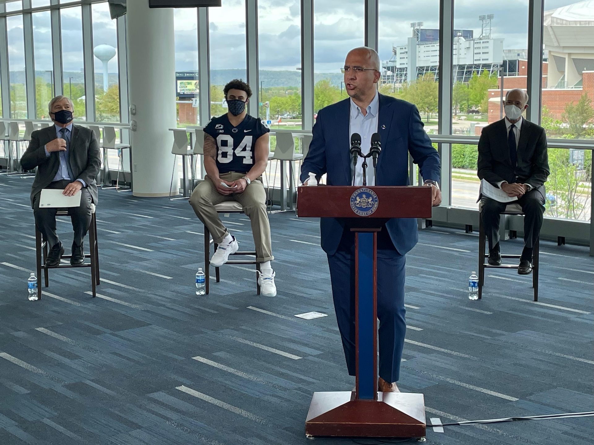 Penn State football coach James Franklin speaks to reporters about the importance of COVID-19 vaccines. Penn State president Eric Barron, freshman football player Theo Johnson and Governor Tom Wolf (seated, L to R) also spoke at the event.
