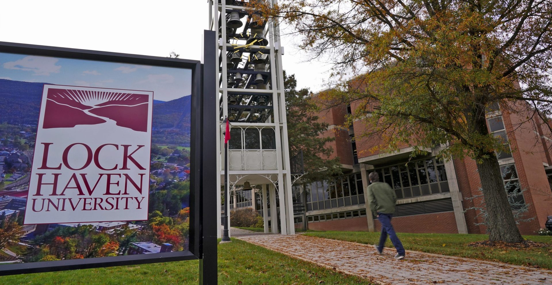 A student walks on the Lock Haven University campus in Lock Haven, Pa, Saturday, Oct. 31, 2020. (AP Photo/Gene J. Puskar)