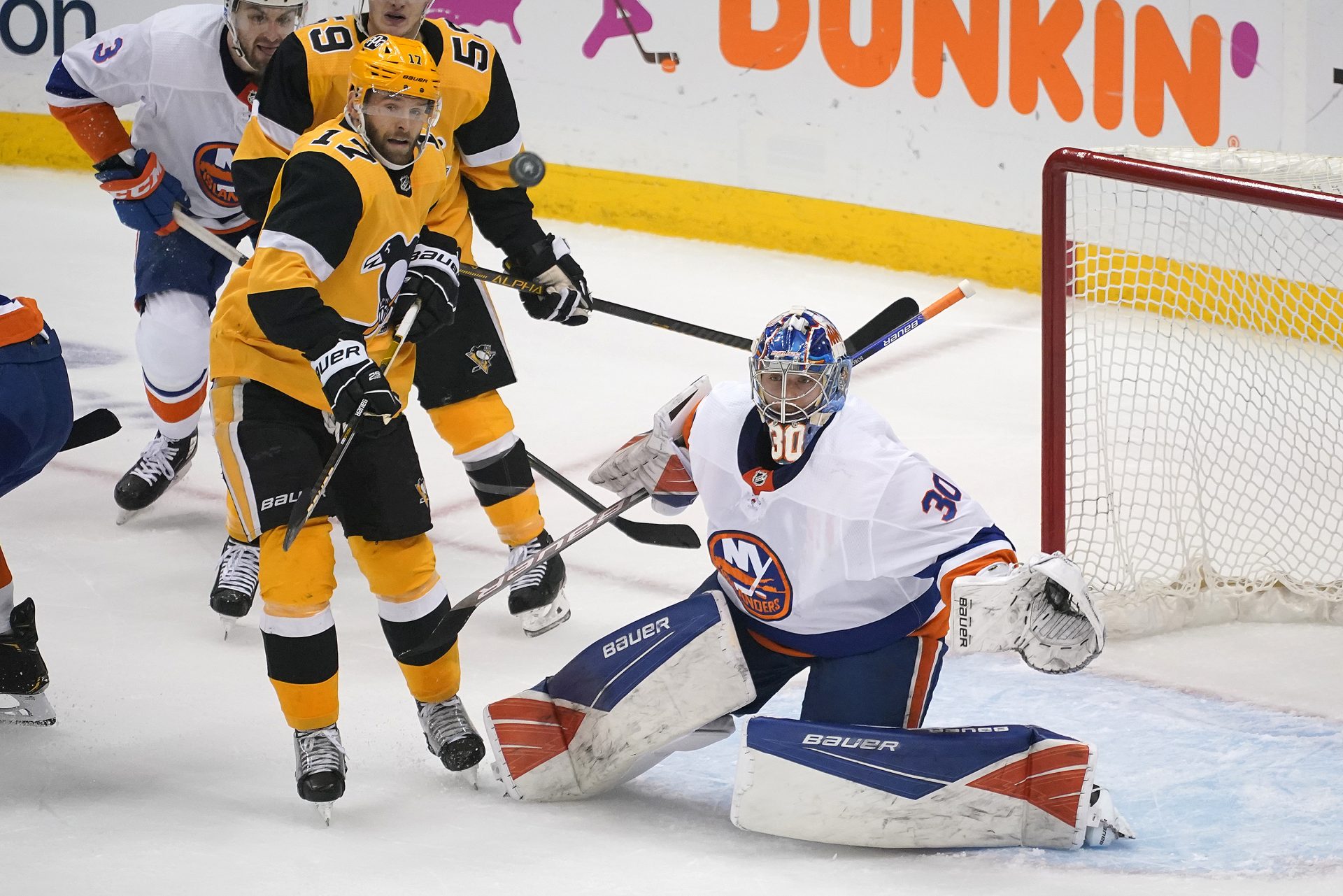 New York Islanders goaltender Ilya Sorokin (30) watches the puck with Pittsburgh Penguins' Bryan Rust (17) looking for a deflection during the first period in Game 5 of an NHL hockey Stanley Cup first-round playoff series in Pittsburgh, Monday, May 24, 2021.