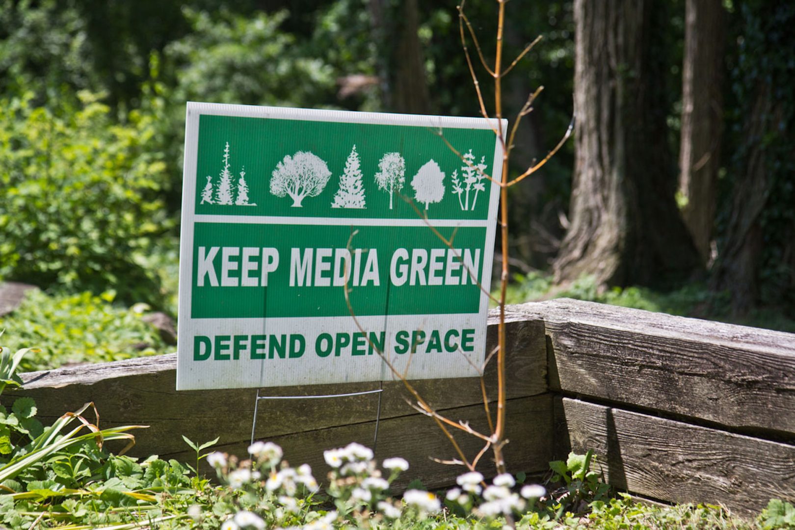 Signs posted in yards around Media, Pa., decry development in the area. (Kimberly Paynter/WHYY)