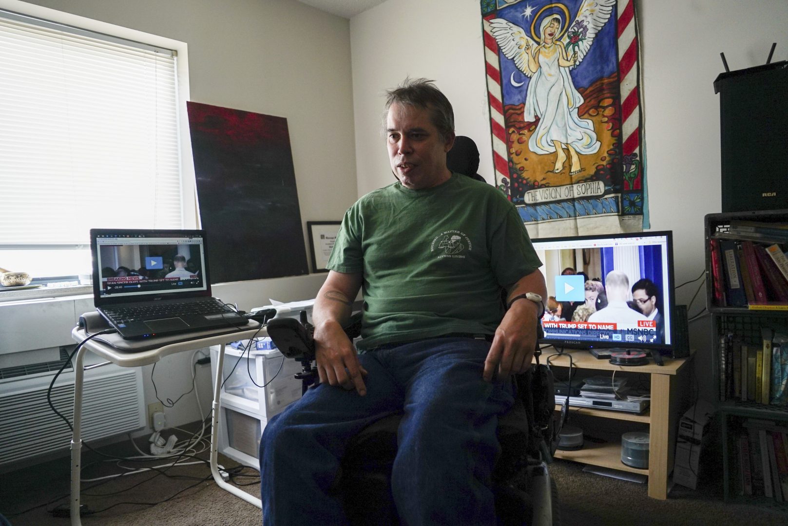 FILE PHOTO: In this July 21, 2017, photo, Darrell Price sits in his power wheelchair in his apartment in Cleveland. Price relies on a Medicaid-funded assistant to help him get dressed, washed and fed.