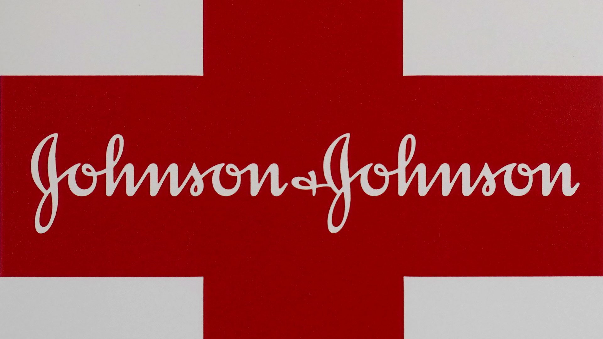 This Feb. 24, 2021 photo shows a Johnson & Johnson logo on the exterior of a first aid kit in Walpole, Mass.  The New York attorney general says Johnson & Johnson has agreed to pay $230 million to settle claims that the pharmaceutical giant helped fuel the opioid crisis. The deal requires Johnson & Johnson to make a series of payments over nine years to cover total.   (AP Photo/Steven Senne)