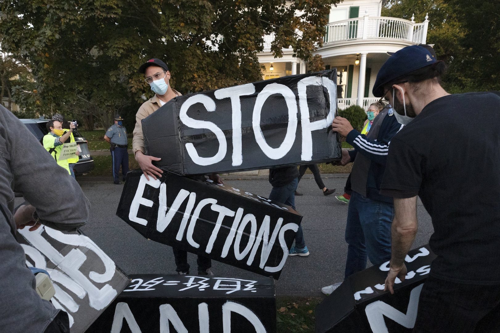 FILE PHOTO: Housing activists erect a sign in front of Massachusetts Gov. Charlie Baker's house in Swampscott, Mass. on Oct. 14, 2020.