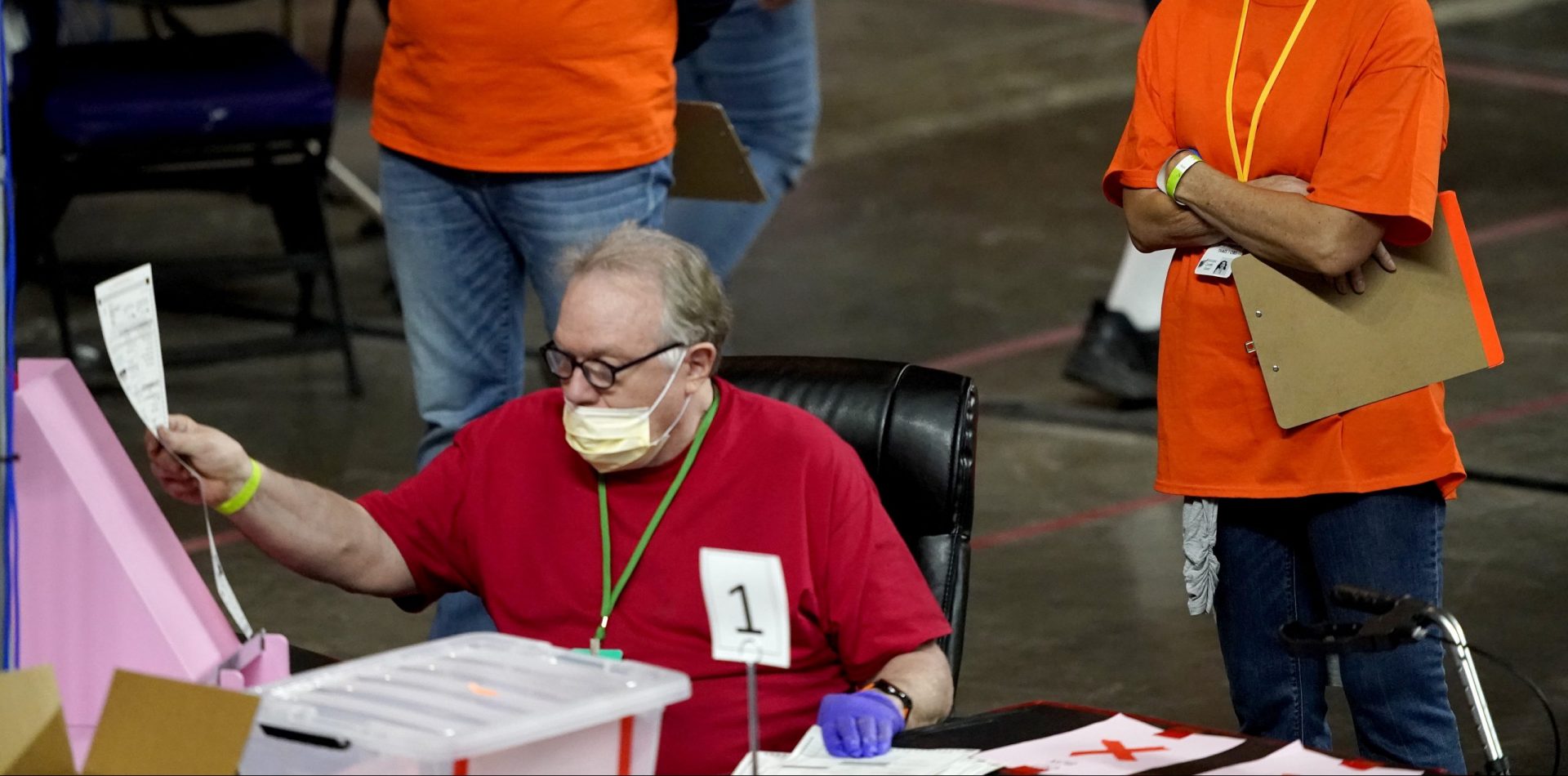 In this May 6, 2021 file photo, Maricopa County ballots cast in the 2020 general election are examined and recounted by contractors working for Florida-based company, Cyber Ninjas at Veterans Memorial Coliseum in Phoenix.