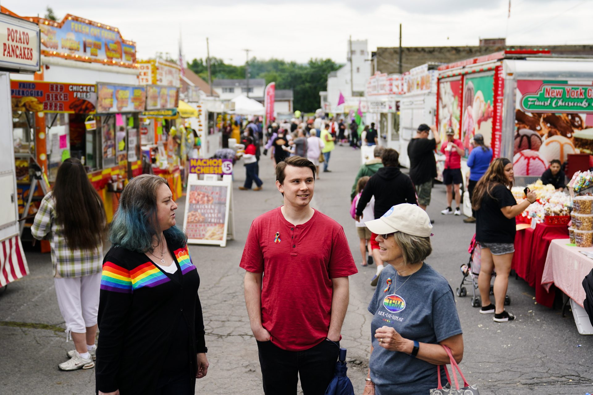 Alisha Hoffman-Mirilovich, left, Mark Shaffer, and Claudia Glennan visit with on another at the Edwardsville Pierogi Festival in Edwardsville, Pa., Friday, June 11, 2021.