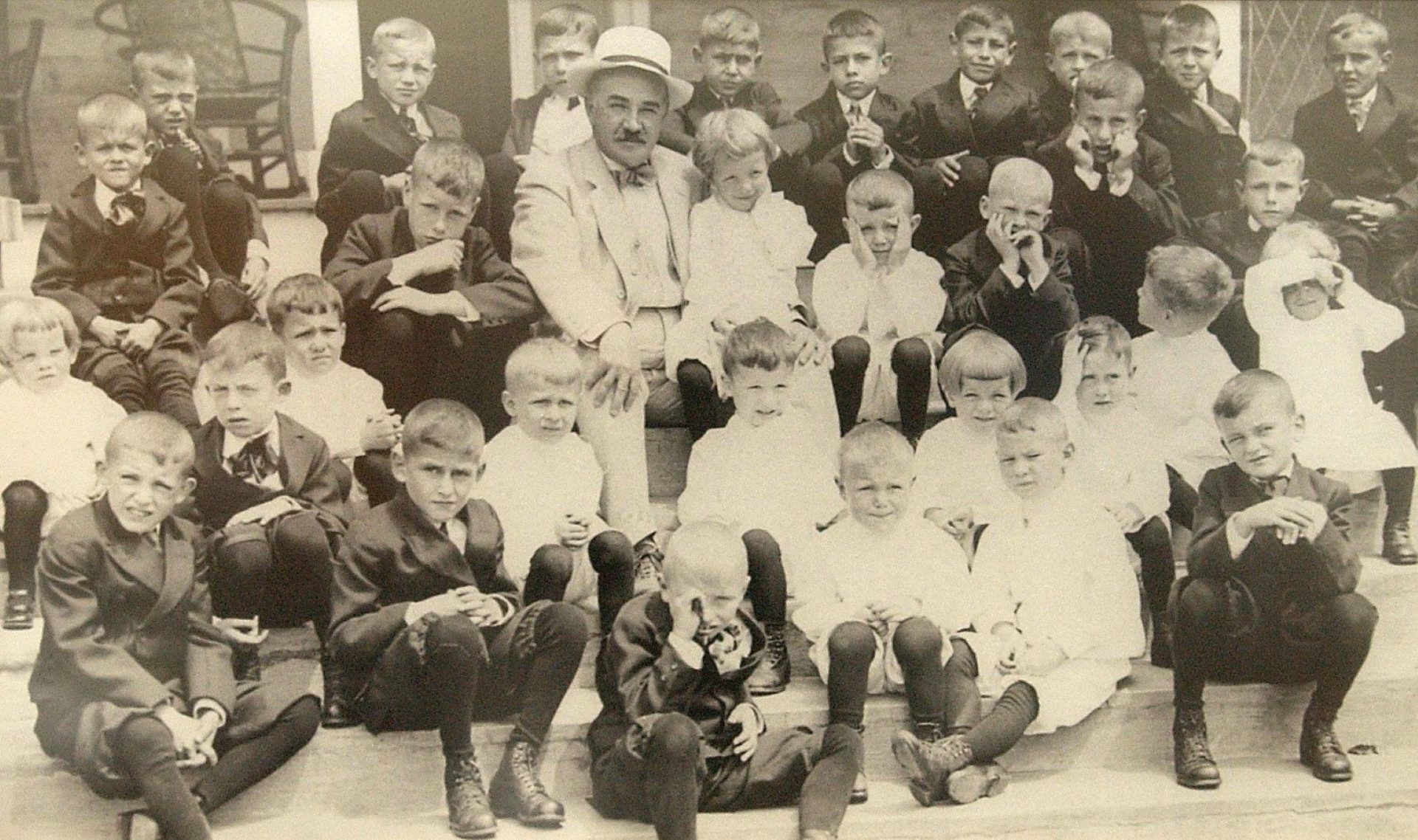  When Milton Hershey founded the school that bears his name in 1909, its mission was to serve “poor, healthy white male orphans, of … ages between four and eight years.” He is pictured here with students in 1913. 