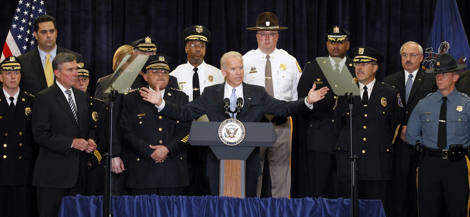 FILE PHOTO: Vice President Joe Biden, center, with members of law enforcement, speaks during a media availability after their roundtable to discuss the impact of budget cuts on their ability to effectively police their communities Tuesday, Oct. 18, 2011, in Philadelphia.