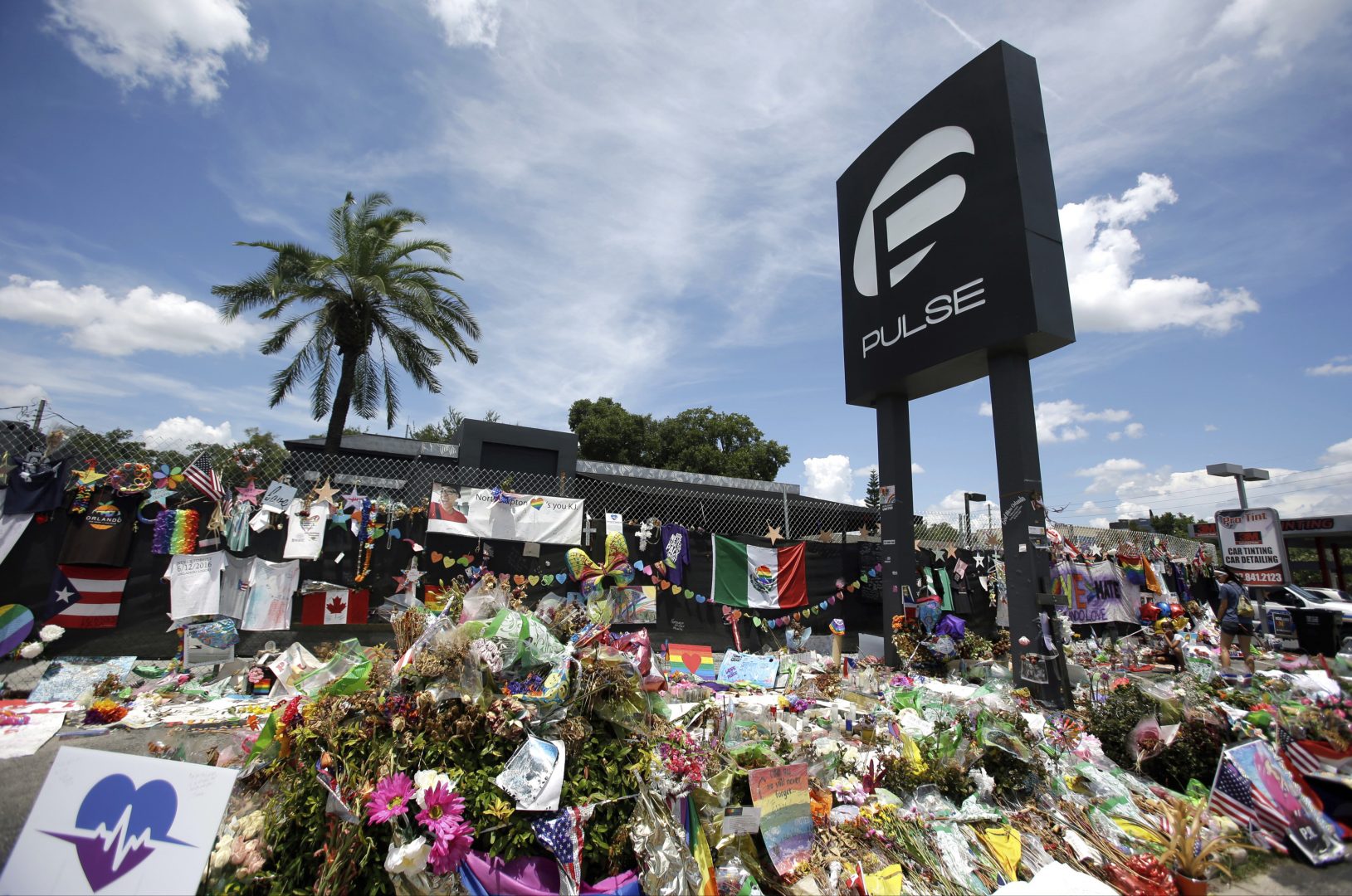 FILE PHOTO: In this July 11, 2016, file photo, a makeshift memorial continues to grow outside the Pulse nightclub in Orlando, the day before the one month anniversary of a mass shooting, in Orlando, Fla.