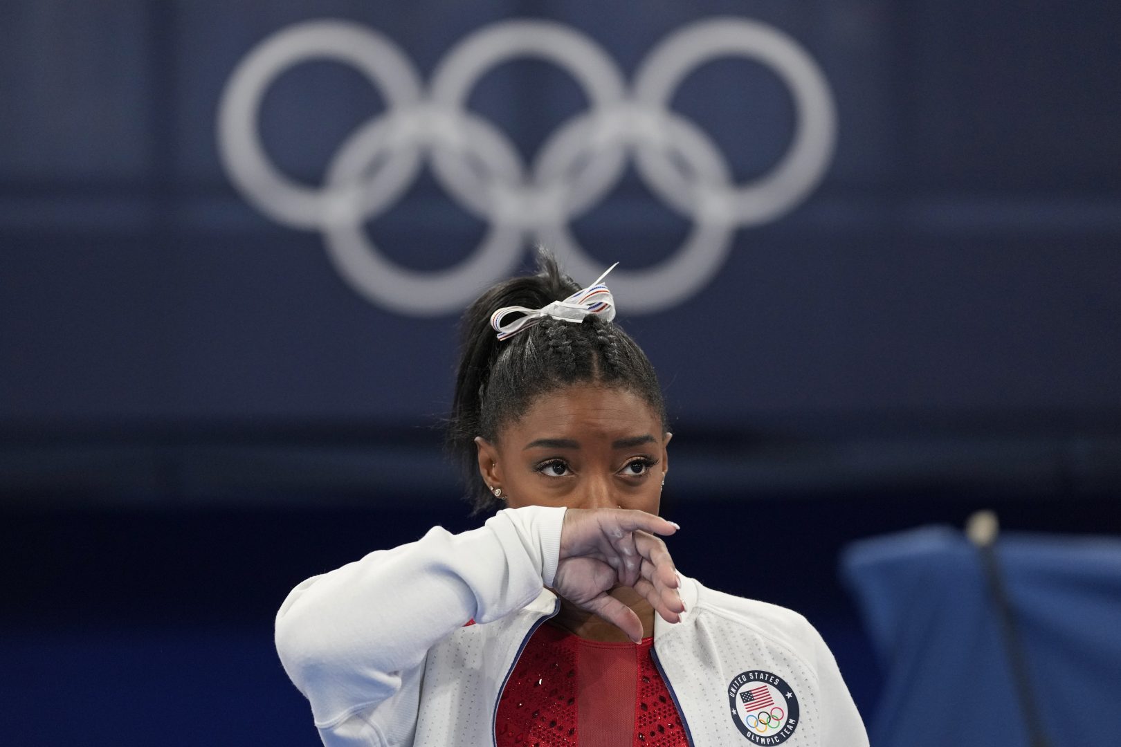 Simone Biles, of the United States, watches gymnasts perform at the 2020 Summer Olympics, Tuesday, July 27, 2021, in Tokyo. Biles says she wasn't in right 'headspace' to compete and withdrew from gymnastics team final to protect herself. 