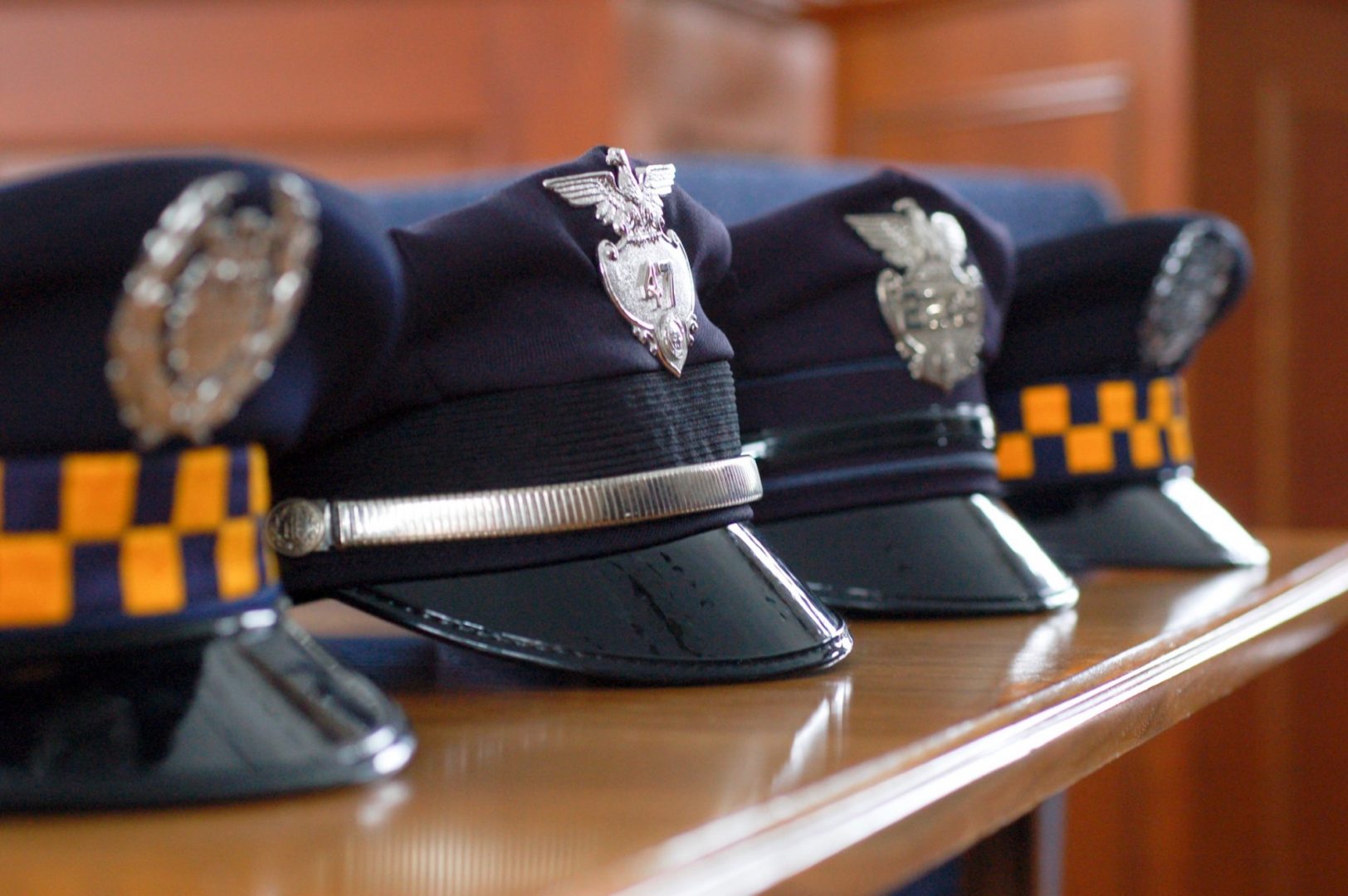 Police hats on a shelf in Pittsburgh.