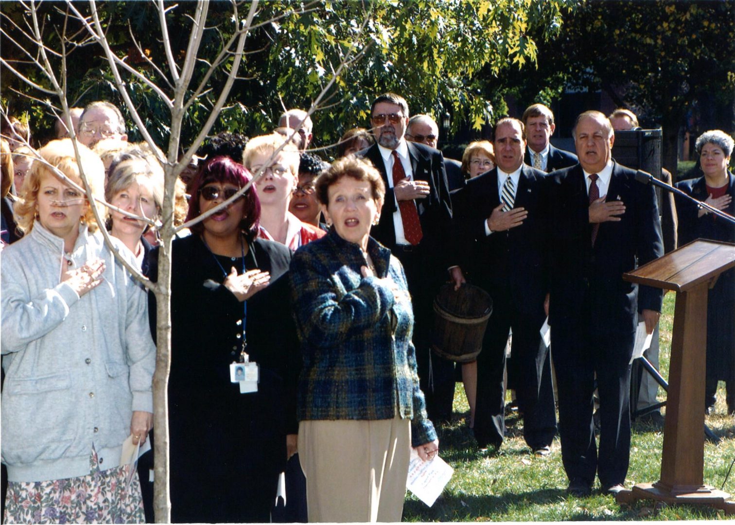 State lawmakers sing a patriotic hymn after a tree is planted on the state Capitol grounds honoring the victims of United Airlines Flight 93 on Oct. 29, 2001. The plane was hijacked by four terrorists on Sept. 11, 2001 and crashed after passengers and crew attempted to retake the cockpit. At center in dark sunglasses, former Rep. Bob Bastian (R-Somerset) who represented the district where Flight 93 crashed. 