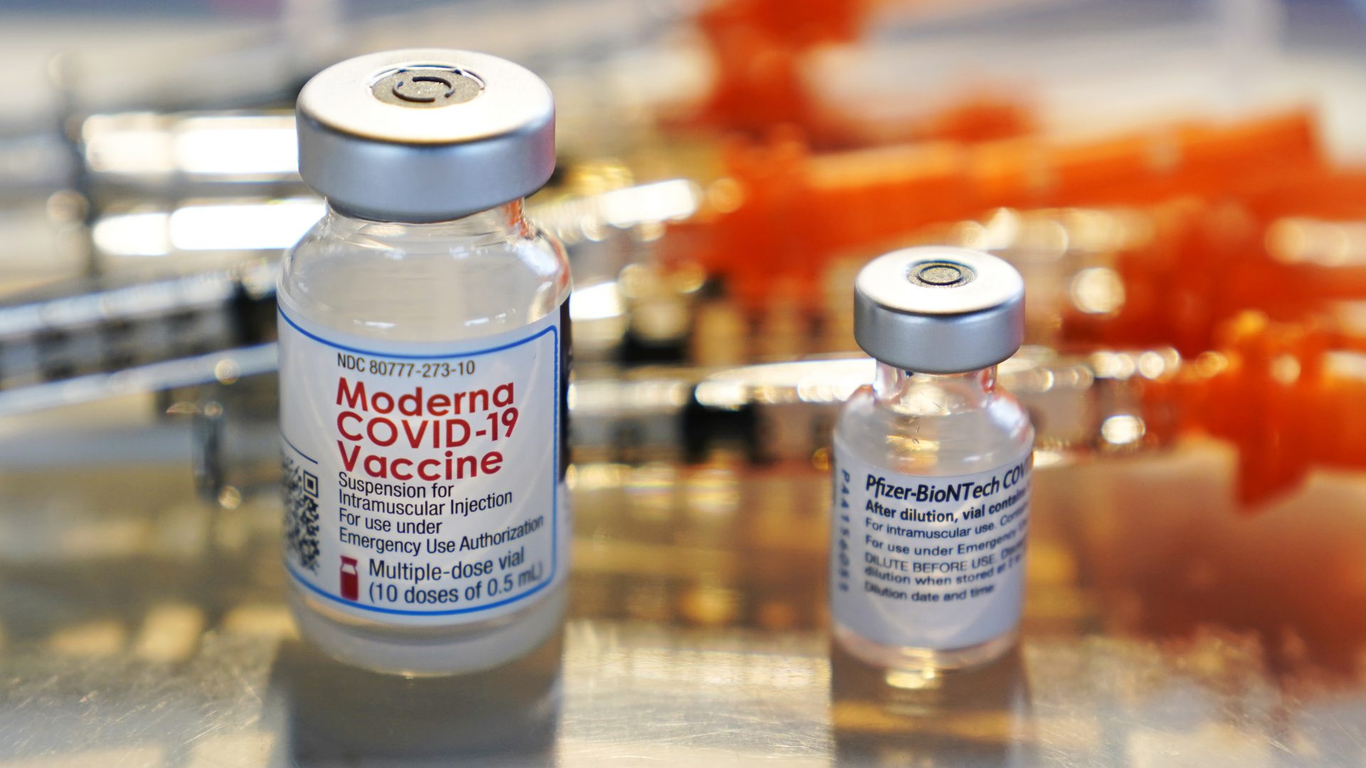 FILE PHOTO: In this Feb. 25, 2021, file photo, vials for the Moderna and Pfizer COVID-19 vaccines are displayed on a tray at a clinic set up by the New Hampshire National Guard in the parking lot of Exeter, N.H., High School.