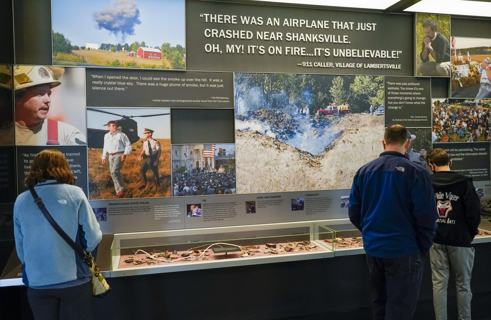 Visitors look over one of the exhibits at the visitors center of the Flight 93 National Memorial, Saturday, May 8, 2021, in Shanksville, Pa.