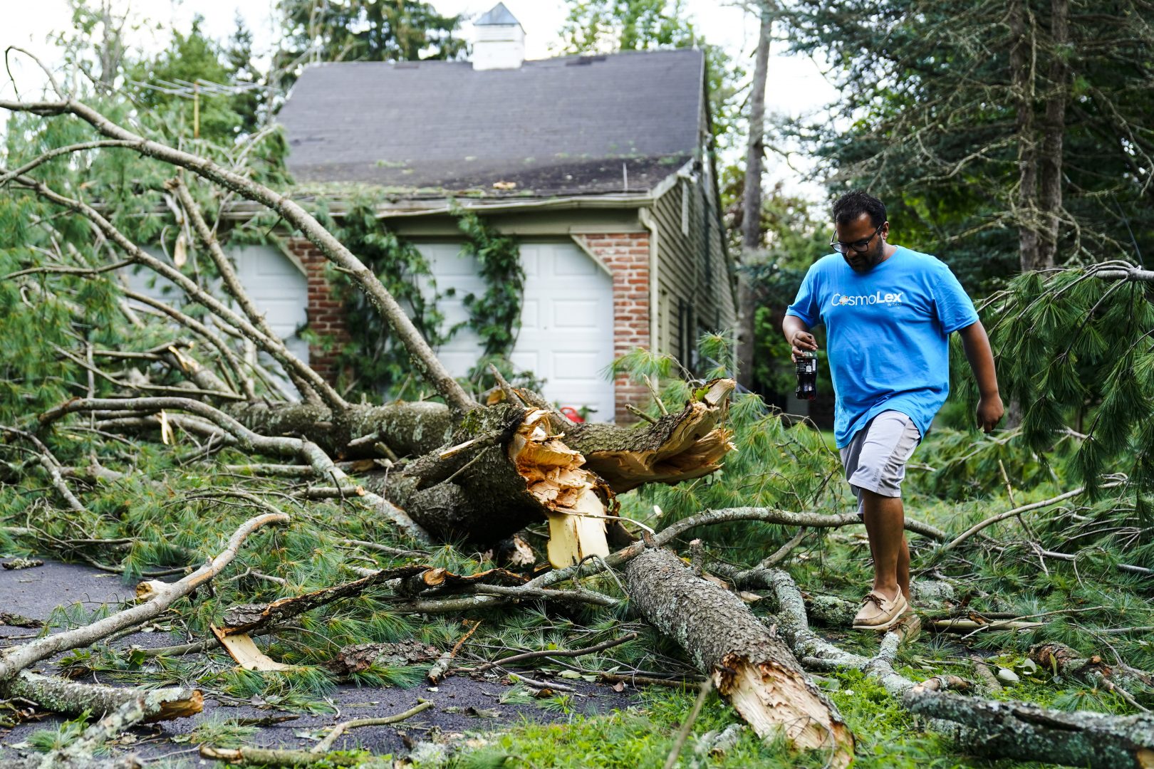 Ajay Khatri inspects his property in the aftermath of a storm in Titusville N.J., Friday, July 30, 2021. AP Photo/Matt Rourke)