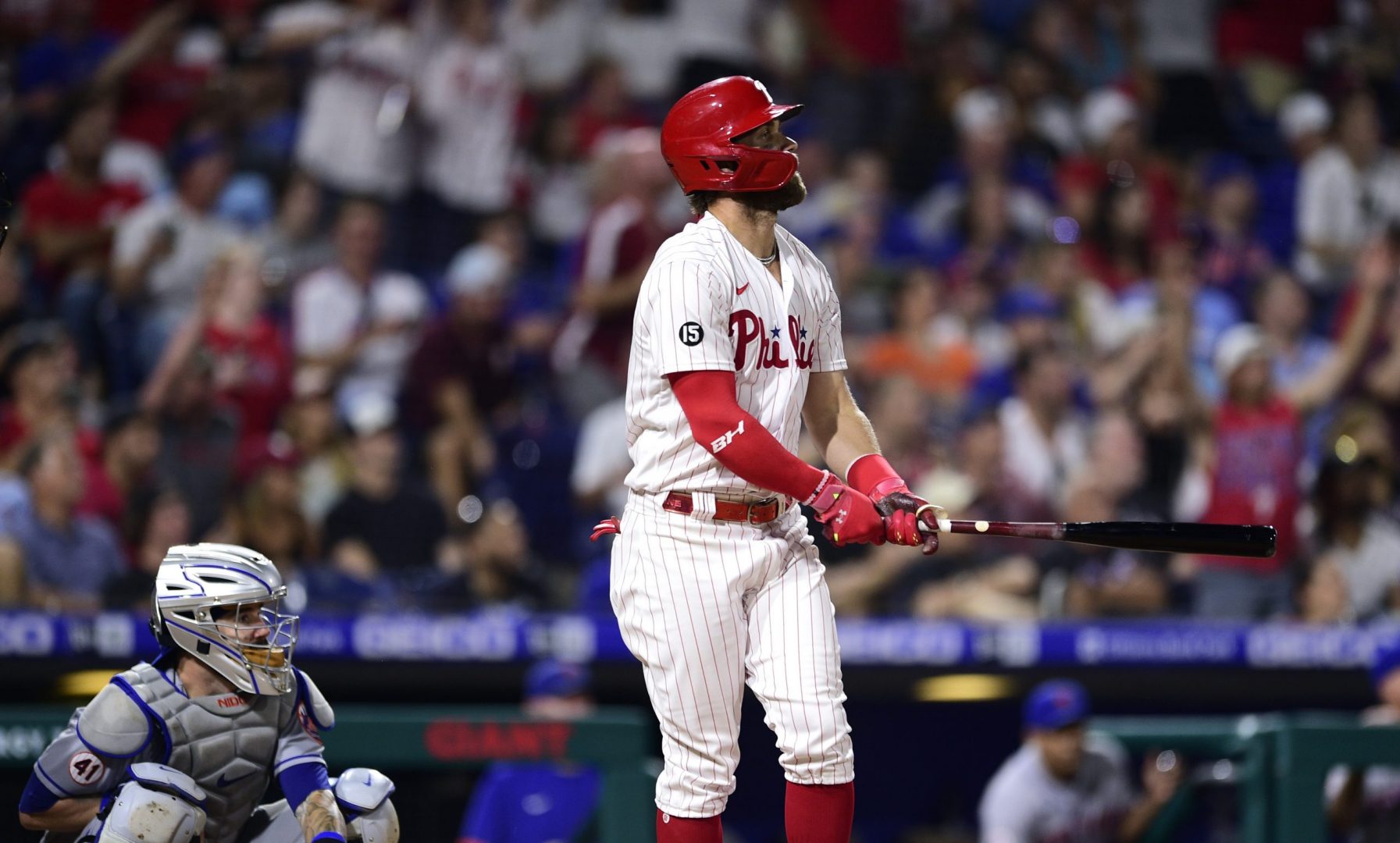 Philadelphia Phillies' Bryce Harper, right, watches his two-run home run off New York Mets' Yennsy Diaz during the eighth inning of a baseball game, Friday, Aug. 6, 2021, in Philadelphia. (AP Photo/Derik Hamilton)