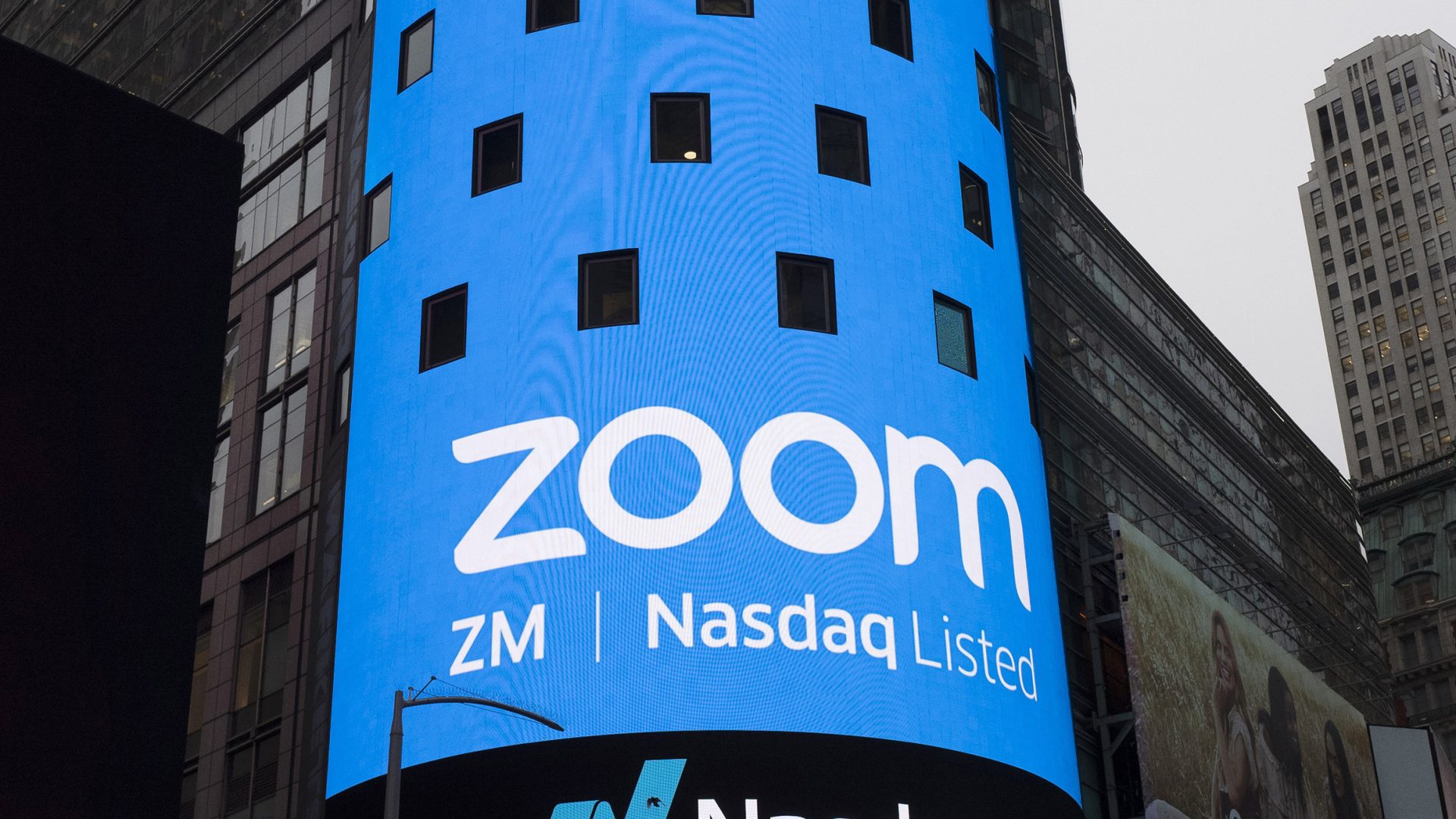 FILE PHOTO: This April 18, 2019, file photo shows a sign for Zoom Video Communications ahead of the company's Nasdaq IPO in New York.