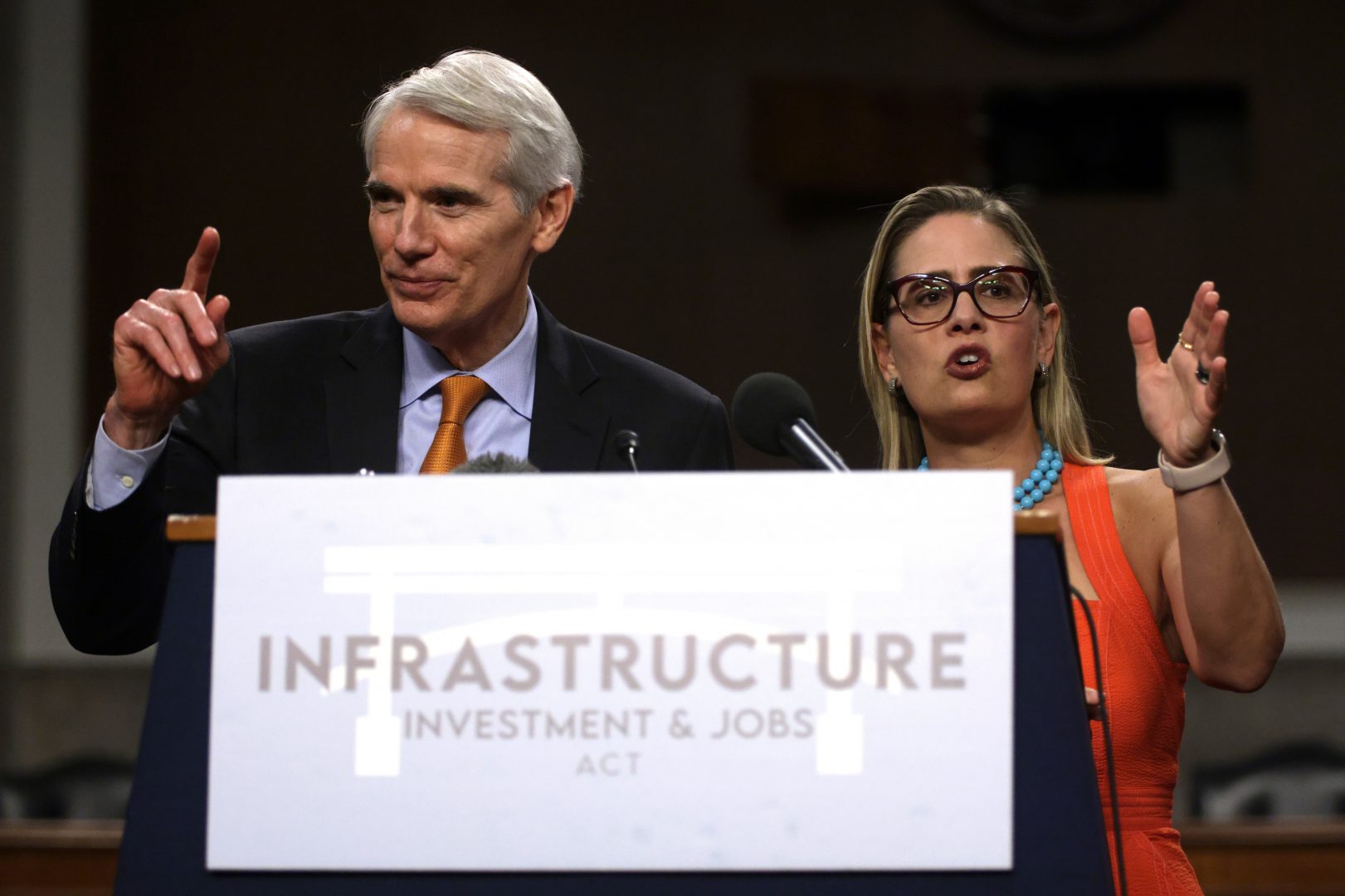Sens. Rob Portman, R-Ohio, and Kyrsten Sinema, D-Ariz., take questions at a news conference last week after a procedural vote for the bipartisan infrastructure framework.