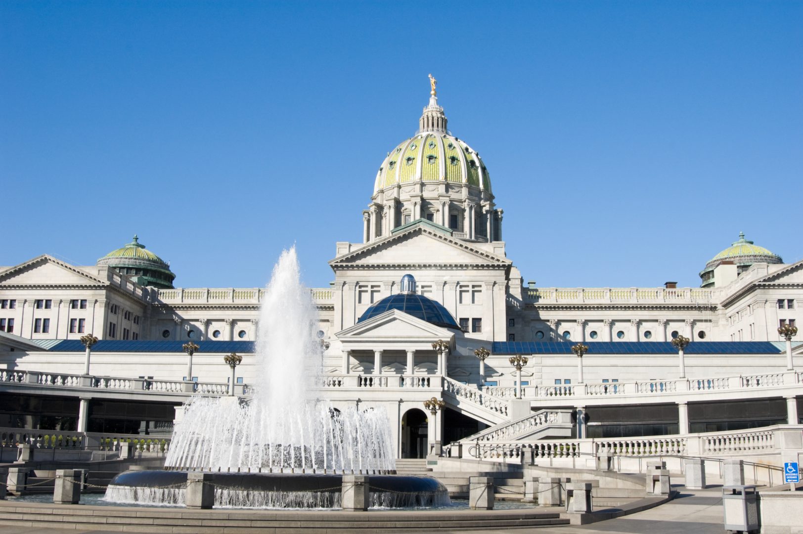 Pennsylvania state capitol government building in Harrisburg, rear view with water fountain and rotunda.