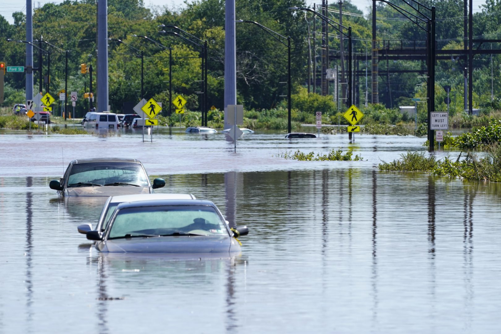 Vehicles are under water during flooding in Norristown, Pa. Thursday, Sept. 2, 2021 in the aftermath of downpours and high winds from the remnants of Hurricane Ida that hit the area. Scientists say climate change is contributing to the strength of storms like Ida.