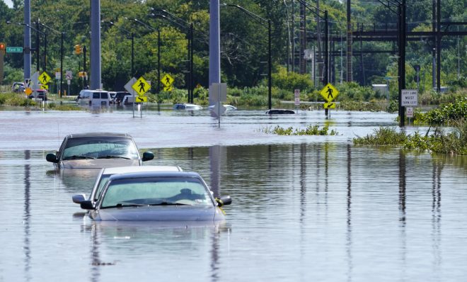 Vehicles are under water during flooding in Norristown, Pa. Thursday, Sept. 2, 2021 in the aftermath of downpours and high winds from the remnants of Hurricane Ida that hit the area. Scientists say climate change is contributing to the strength of storms like Ida.