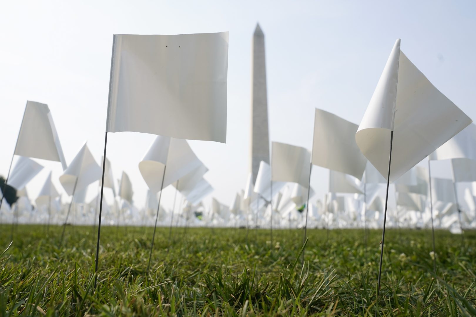 White flags stand near the Washington Monument on the National Mall in Washington, Tuesday, Sept. 14, 2021. The flags, which will number more than 630,000 when completed, are part of artist Suzanne Brennan Firstenberg's temporary art installation, 