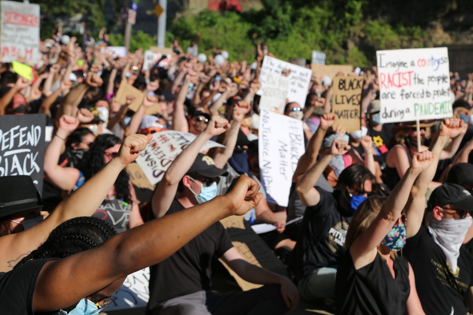 FILE PHOTO: Black Lives Matter protesters sit, with their fists raised, in Pittsburgh.