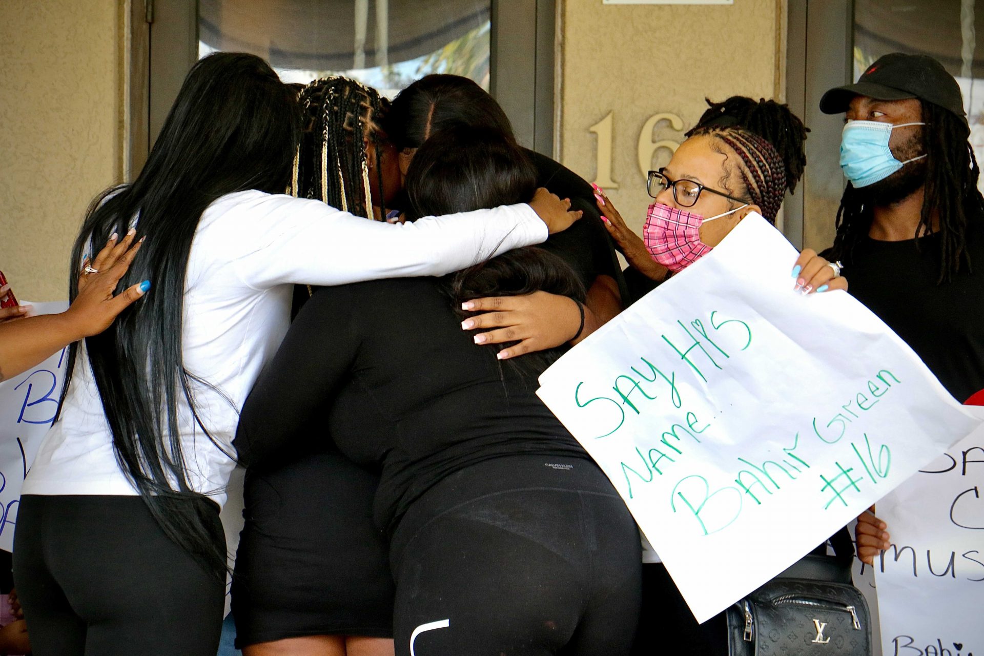 Bahir Green’s sisters and supporters comfort each other during a press conference in front of Chester police headquarters. The 16-year-old was arrested Friday and remains in custody.