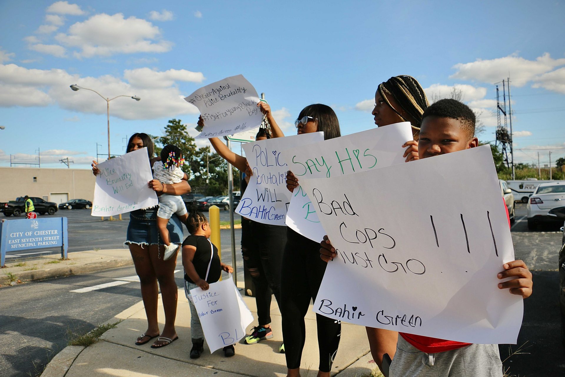 Family members and supporters of Bahir Green carry handmade signs to a press conference at Chester police headquarters. The 16-year-old remains in custody after his arrest Friday, Sept. 17, 2021. A video appeared to show police beating him while making the arrest.