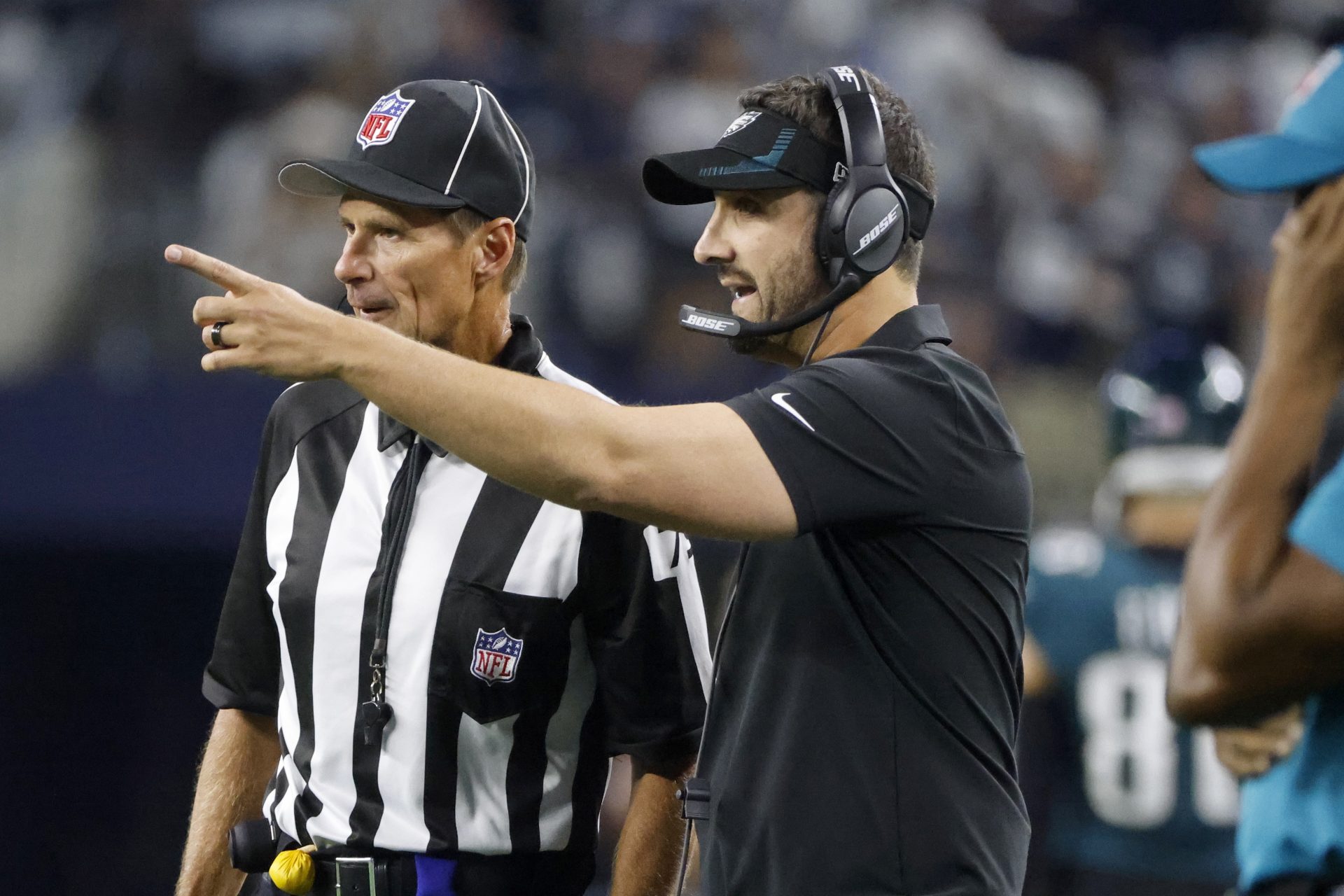 Philadelphia Eagles head coach Nick Sirianni, front, talks with an official in the first half of an NFL football game against the Dallas Cowboys in Arlington, Texas, Monday, Sept. 27, 2021.