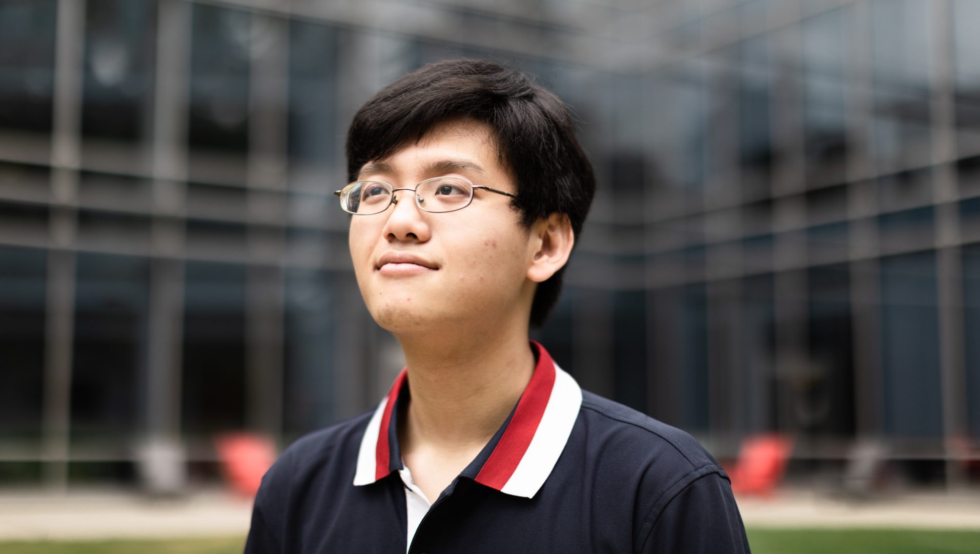 An Ho-Ngoc Nguyen sits for a portrait at George Mason University, where he completed his undergraduate degree and is currently pursuing his Masters.