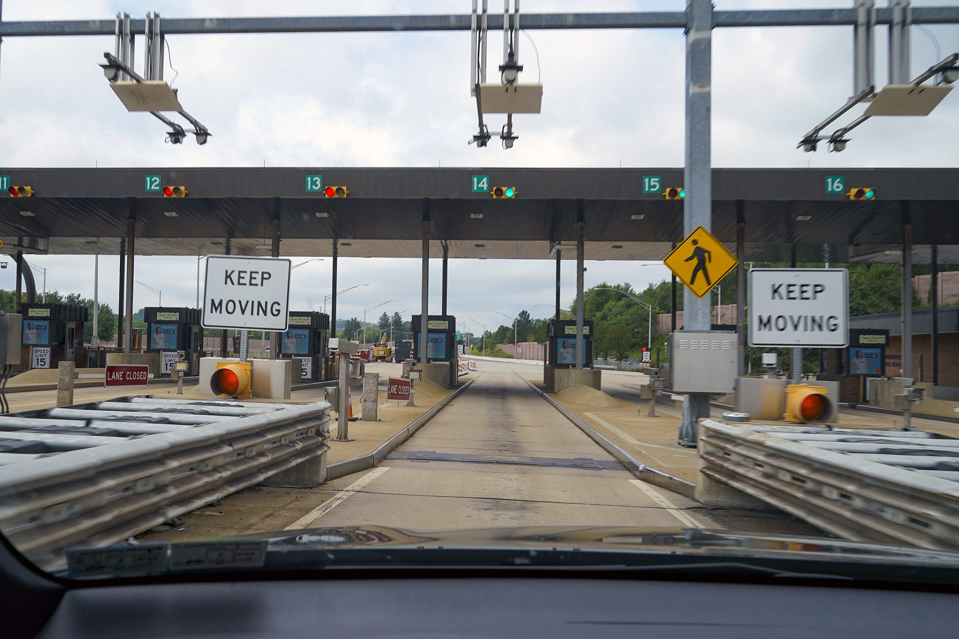 In this photo made through a windshield, the sensors and lights are seen at the west bound toll gate of the Pennsylvania Turnpike in Cranberry Township, Pa., on Monday, Aug. 30, 2021.