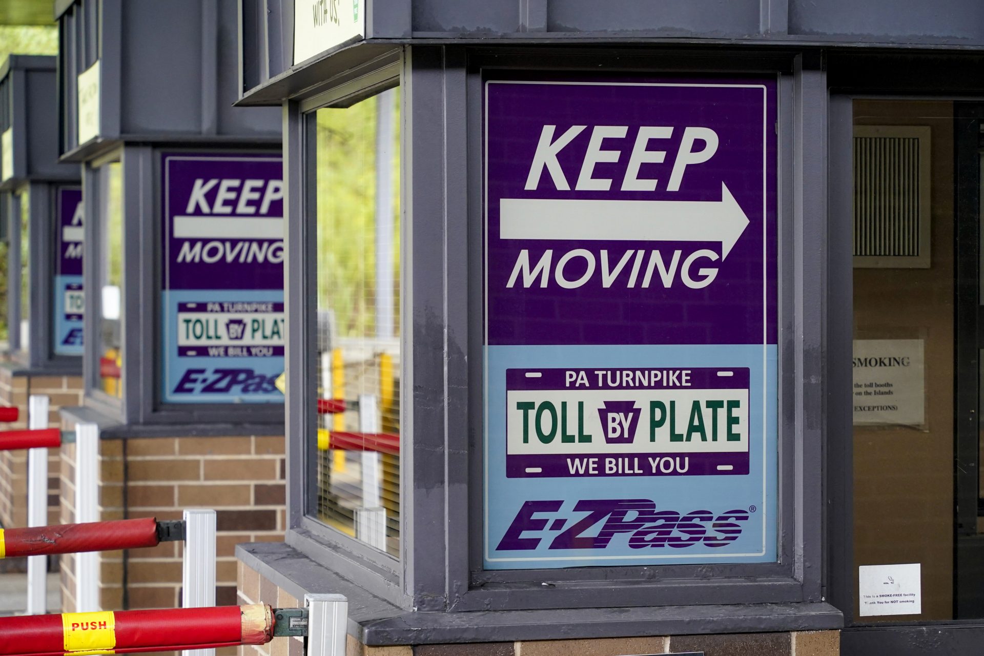 Signs on the electronic toll booths indicate to motorists entering the Pennsylvania Turnpike in Gibsonia, Pa. on Monday, Aug. 30, 2021, to keep moving and the methods being used to collect tolls.
