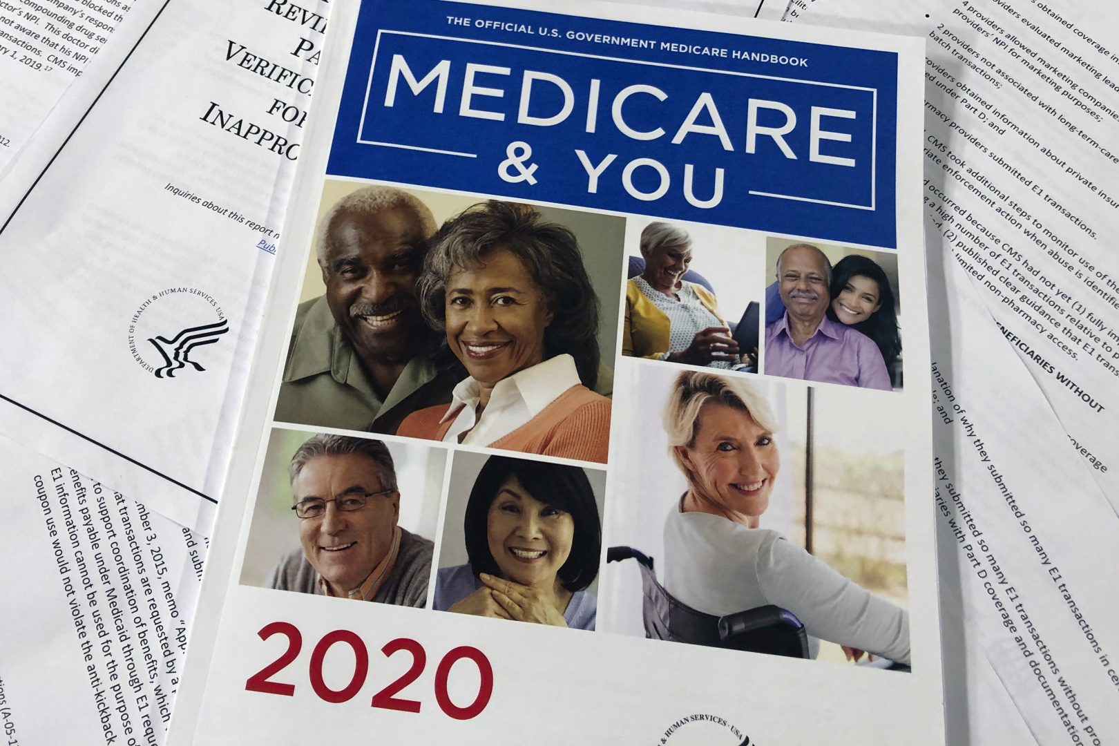 FILE PHOTO: In this Feb. 13, 2020, file photo, The Official U.S. Government Medicare Handbook for 2020 over pages of a Department of Health and Human Services, Office of the Inspector General report, are shown in Washington.